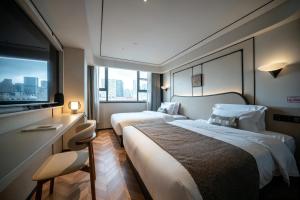 a hotel room with two beds and a window at Neyar Luxury and Tranquil Aesthetics Hotel-Prime Location,8-min Walk to Chunxi Road & Sino-Ocean Taikoo Li in Chengdu