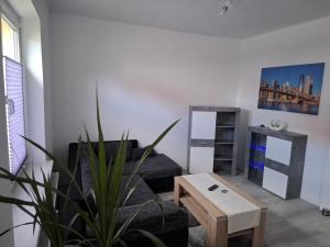 a living room with a couch and a table at FeWo s Runde Wiese WR in Greifswald +28 photos