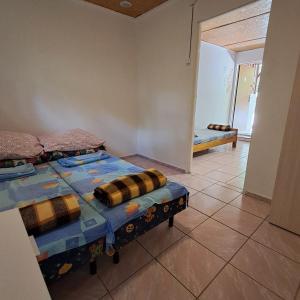 a bedroom with two beds in a room with a hallway at Domki Wakacyjne nad Jeziorem in Janowice