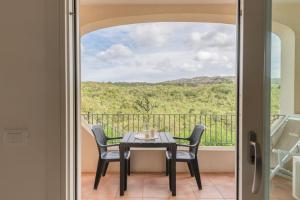 a table and chairs on a balcony with a view at Chic Residence Ea Bianca 1 Bed Apartment sleeps 4 in Cala Bitta +82 photos