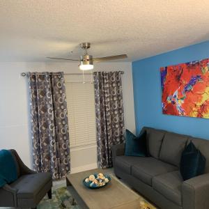 a living room with a couch and a table at Villa del Sol Condo,inum in Kissimmee