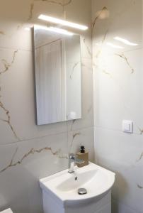 a bathroom with a white sink and a mirror at VenisHome 1 in Chaïdeftón +87 photos