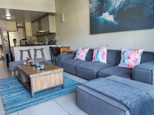 a living room with a couch and a coffee table at Stay at the Herold 605 in Herolds Bay