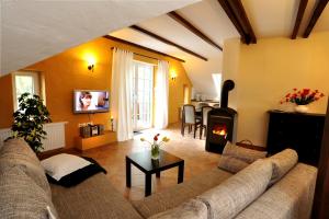 a living room with a couch and a fireplace at KASTANIENHOF I in Burg