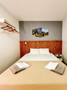 a bedroom with a large bed with two towels on it at Casa Quebec - Apartamentos in São Miguel do Gostoso +91 photos