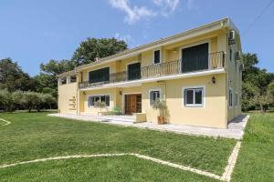a house with a large yard in front of it at Yi Garden Corfu in Corfu