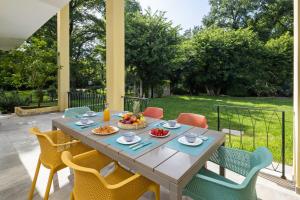 a table with a bowl of fruit on a patio at Yi Garden Corfu in Corfu