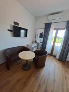 a living room with a couch and a table at Apartments and Rooms "Almira" in Pula