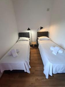two beds sitting next to each other in a room at Apartments and Rooms "Almira" in Pula