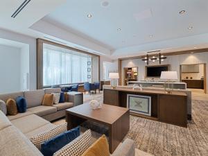 a living room with a couch and a table at Drury Inn & Suites Destin Miramar Beach in Destin