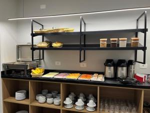 a shelf filled with different types of food at Polar Rio Hotel in São Paulo