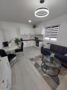a living room with a couch and a table at Apartman Gordana i Andreas in Banja Koviljača