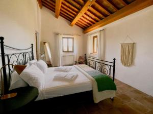 a bedroom with a large bed in a room at Casale Milleluci - Country House in Senigallia
