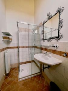 a bathroom with a glass shower and a sink at Casale Milleluci - Country House in Senigallia +111 photos