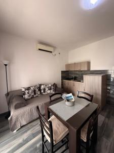 a living room with a table and a couch at Belane Apartments in Tivat +17 photos