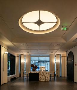 a large lobby with a large circular light fixture at Neyar Luxury and Tranquil Aesthetics Hotel-Prime Location,8-min Walk to Chunxi Road & Sino-Ocean Taikoo Li in Chengdu
