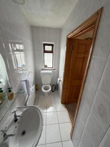 a white bathroom with a toilet and a sink at Simple Stay Foxford in Foxford