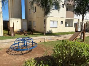 a playground with blue hoops and a slide at Lazer Oceanos in São Vicente