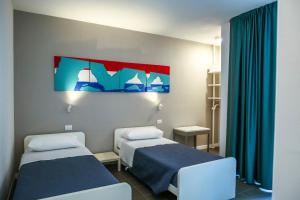 Postel nebo postele na pokoji v ubytování B&B WarmUp Grosseto - Parcheggio incluso nella corte interna