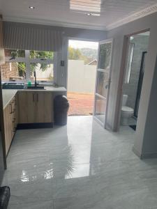 a kitchen with a sink and a toilet in it at Abijah Ridgeview Studios in Roodepoort +105 photos