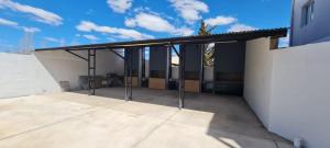 a building with awning on top of a patio at uriburu45 in Malargüe
