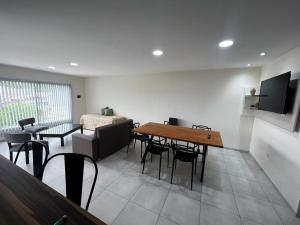 a living room with a table and chairs and a couch at uriburu45 in Malargüe