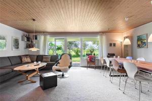 a living room with a couch and a table at FY175-Asperup-Sommerlandsvej-4 in Asperup