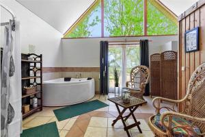 a large bathroom with a tub and a large window at FY175-Asperup-Sommerlandsvej-4 in Asperup