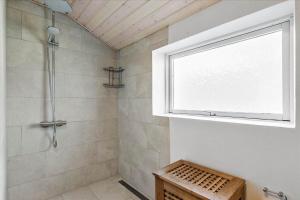 a bathroom with a shower with a window at FY175-Asperup-Sommerlandsvej-4 in Asperup +17 photos
