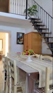 a dining room table with a bowl of fruit on it at Casa vacanza La Dimora in San Pancrazio Salentino