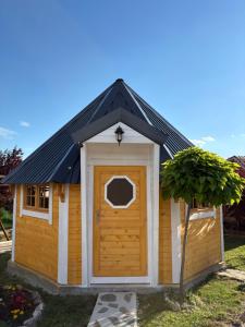 a large wooden dog house with a door at MERAK STD in Vranje