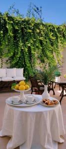 a table with plates of food and fruit on it at Casa vacanza La Dimora in San Pancrazio Salentino