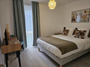 a bedroom with a large bed and a window at DOMITYS - Les Passementiers in Villars