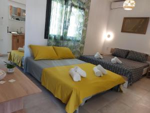 a living room with two beds and a couch at Sky Rooms in Nea Kallikrateia