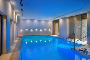 a swimming pool in a building with a blue lighting at DOMITYS - Les Passementiers in Villars