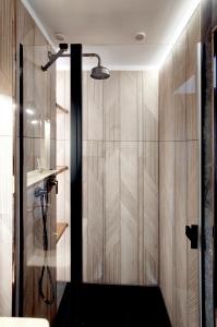 a shower with a glass door in a bathroom at Czarny Jeleń in Zakopane