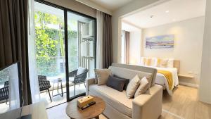 a living room with a couch and a bed at Stylish Diamond Condo Bangtao with Pool View in Bang Tao Beach