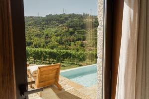 a room with a window with a view of a pool at Serpa Pinto Village - Private Pool - by FERO in Cinfães