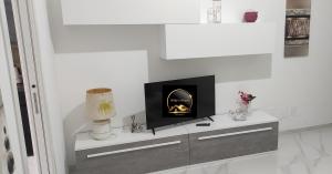 a white living room with a fireplace on a dresser at Willys House Barletta in Barletta