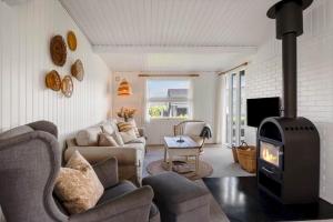 a living room with a wood stove in it at FY402-Asperup-Eskelundsvaenget-9 in Voldby