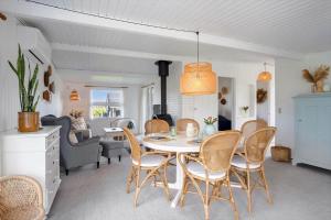 a dining room and living room with a table and chairs at FY402-Asperup-Eskelundsvaenget-9 in Voldby +22 photos