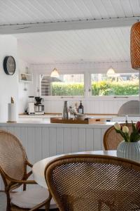 a kitchen with a table and chairs and a counter at FY402-Asperup-Eskelundsvaenget-9 in Voldby