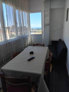 a room with a table and chairs and a large window at Eclisse quinto piano senza ascensore in Palermo