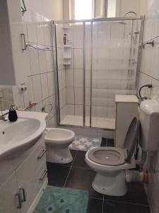 a bathroom with a toilet and a sink and a shower at Eclisse quinto piano senza ascensore in Palermo +3 photos