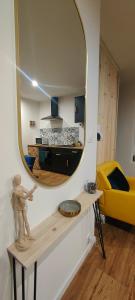a living room with a mirror on the wall at OasisNoir in Calonne-Ricouart