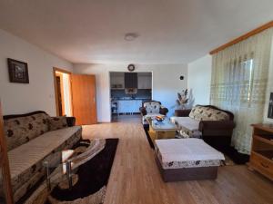 a living room with two couches and a table at Vikendica Twins in Donji Vakuf