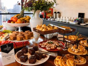 a buffet of different types of food on a table at Intercity Faria Lima Address in São Paulo