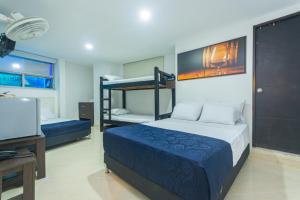 a bedroom with two bunk beds and a television at Hotel Los Angeles Bello in Bello +22 photos