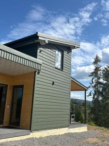 a small house with a window on the side of it at Evergreen cottage in Slavske