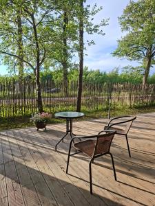 a table and two chairs and a table and a table and chairs at DEIVID house for rent in Skulte